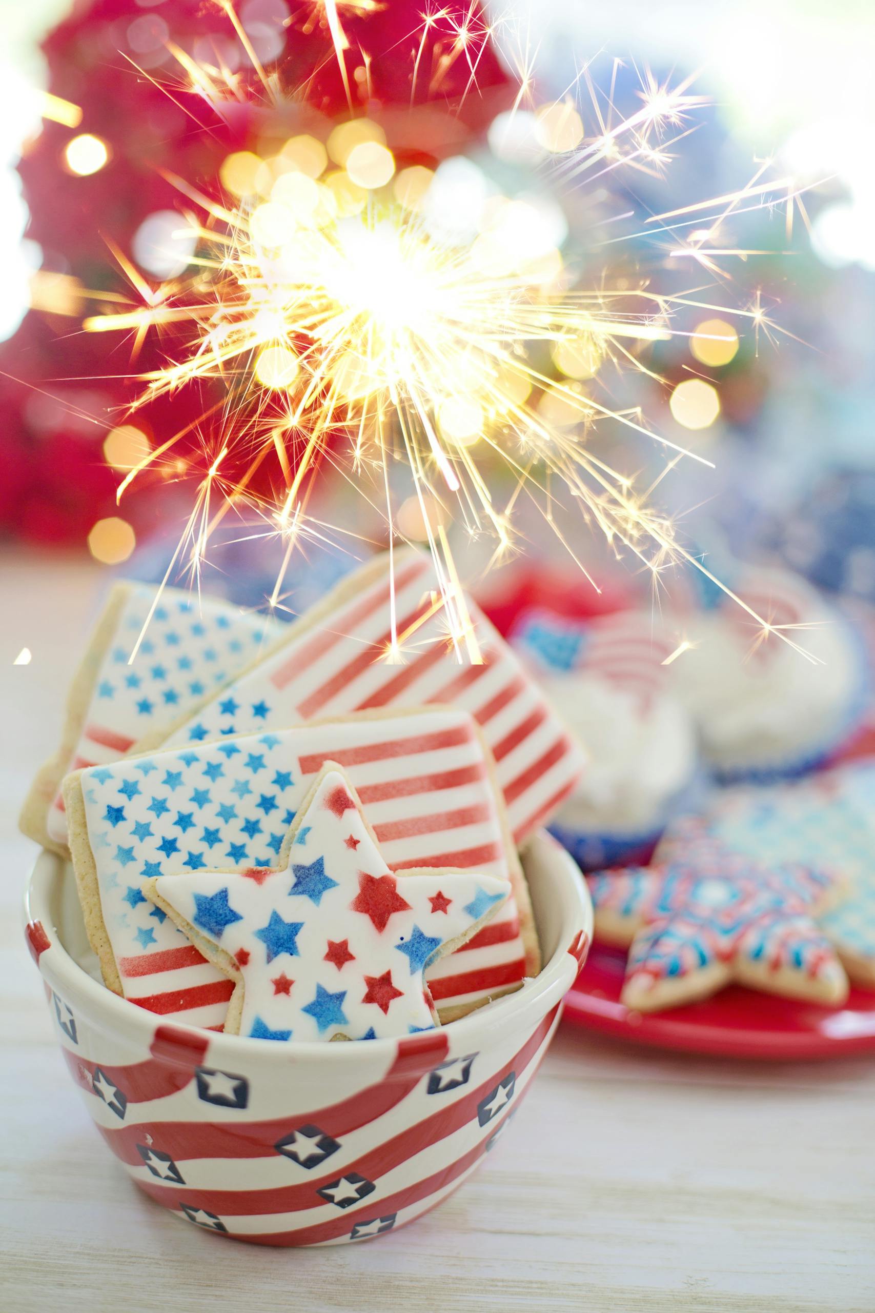Festive American flag cookies with a sparkler celebrating Independence Day.